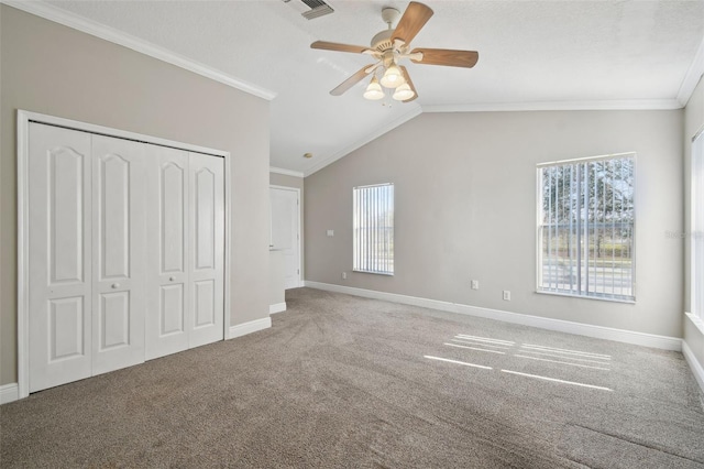 unfurnished bedroom with vaulted ceiling, ornamental molding, ceiling fan, and a closet