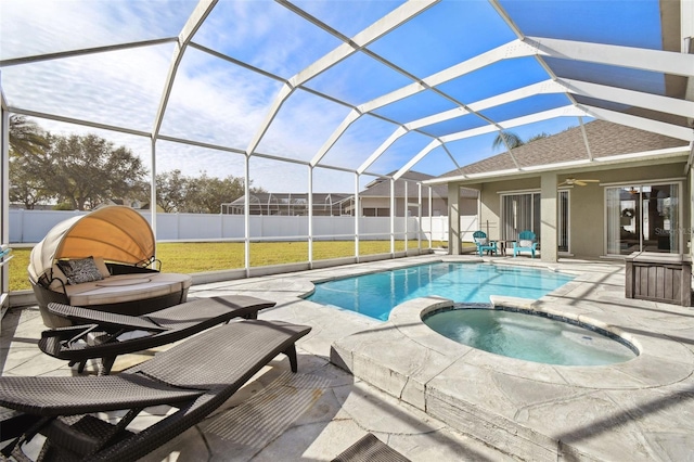 view of pool with a lanai, an in ground hot tub, and a patio area