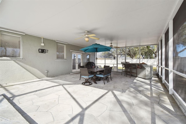 sunroom / solarium featuring ceiling fan