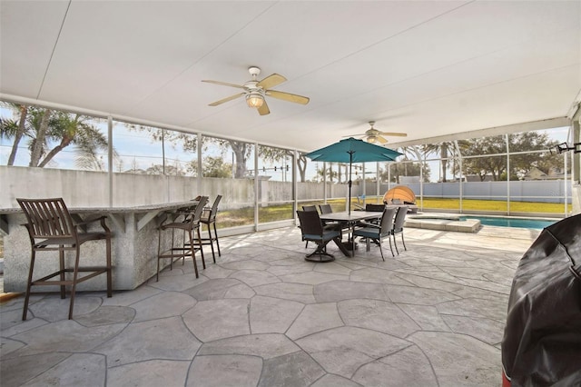 sunroom / solarium featuring ceiling fan