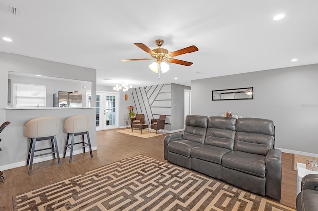 living room featuring ceiling fan, french doors, plenty of natural light, and hardwood / wood-style floors