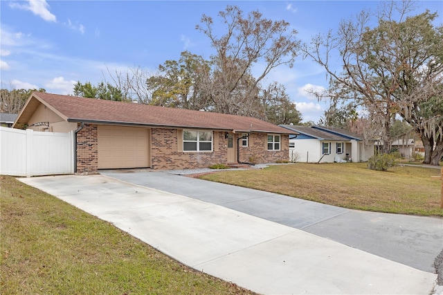 ranch-style home with a garage and a front lawn