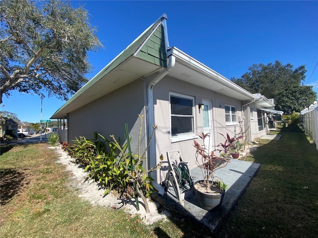 view of property exterior with a yard