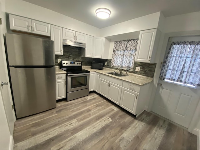 kitchen with stainless steel appliances, light hardwood / wood-style floors, sink, and white cabinets