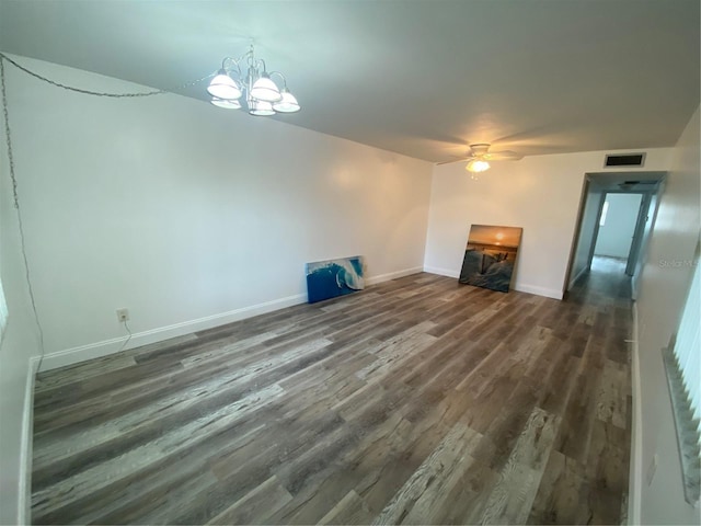 unfurnished living room featuring dark wood-type flooring and ceiling fan with notable chandelier