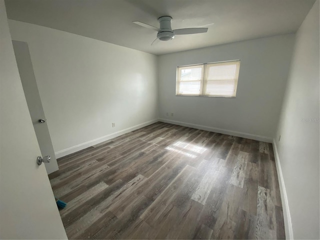 empty room featuring dark hardwood / wood-style floors and ceiling fan