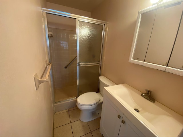 bathroom featuring vanity, tile patterned floors, toilet, and walk in shower