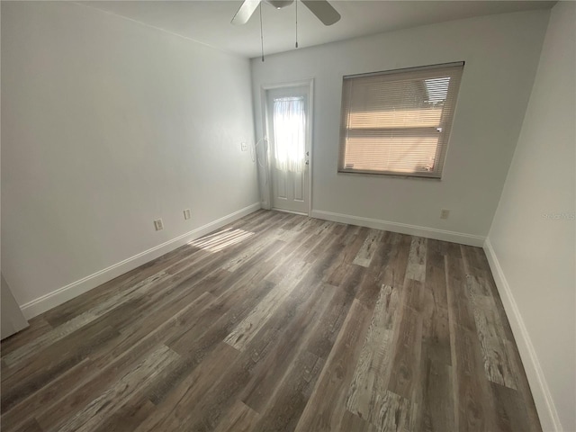 unfurnished room with dark hardwood / wood-style floors and ceiling fan