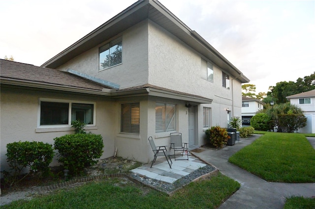 back of house with a lawn