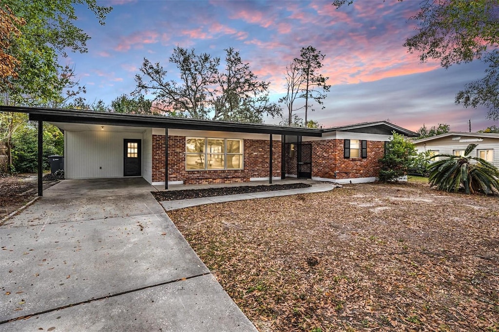 single story home featuring a carport