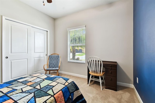 bedroom featuring light carpet, a closet, and ceiling fan