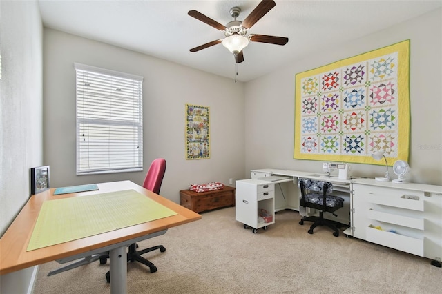 office space featuring ceiling fan and light colored carpet