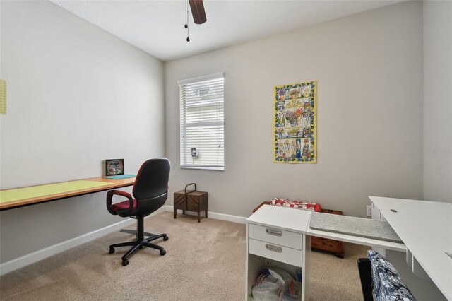 home office featuring ceiling fan and light colored carpet