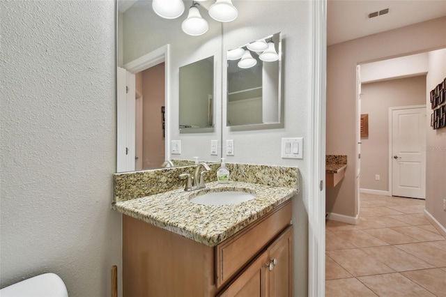 bathroom with tile patterned flooring and vanity