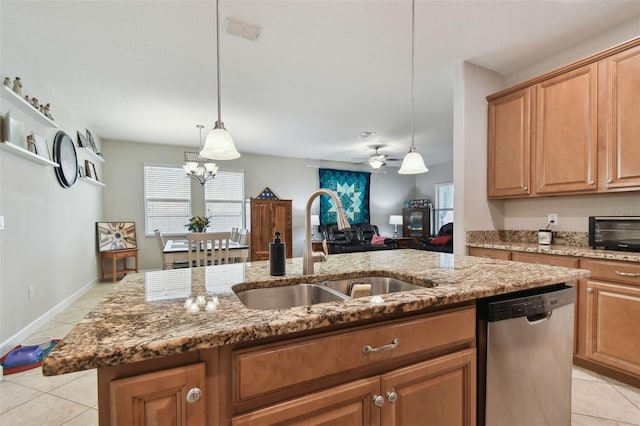 kitchen featuring pendant lighting, stainless steel dishwasher, a center island with sink, sink, and ceiling fan with notable chandelier