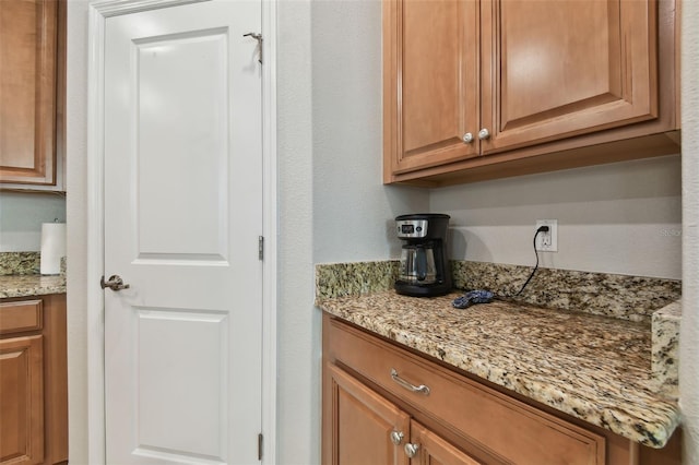 bar featuring light stone countertops