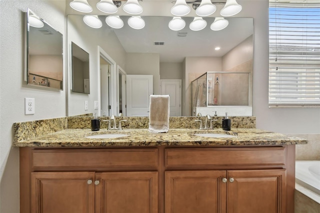 bathroom with vanity and independent shower and bath