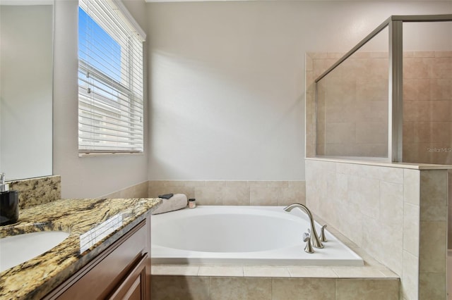 bathroom with separate shower and tub and vanity