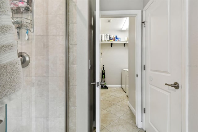 bathroom featuring a tile shower and tile patterned flooring