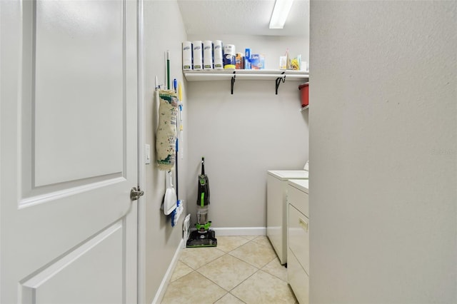 washroom featuring washer and dryer and light tile patterned floors