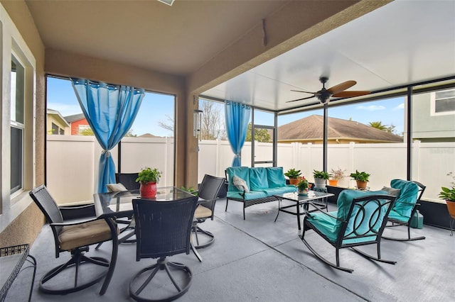 sunroom / solarium with ceiling fan and a healthy amount of sunlight