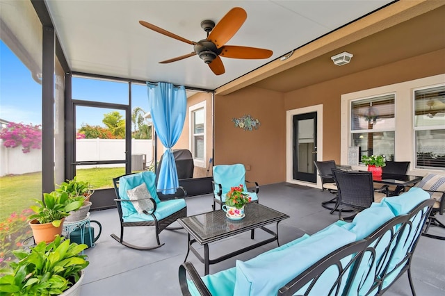 sunroom featuring ceiling fan