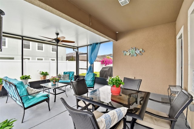 sunroom / solarium featuring ceiling fan