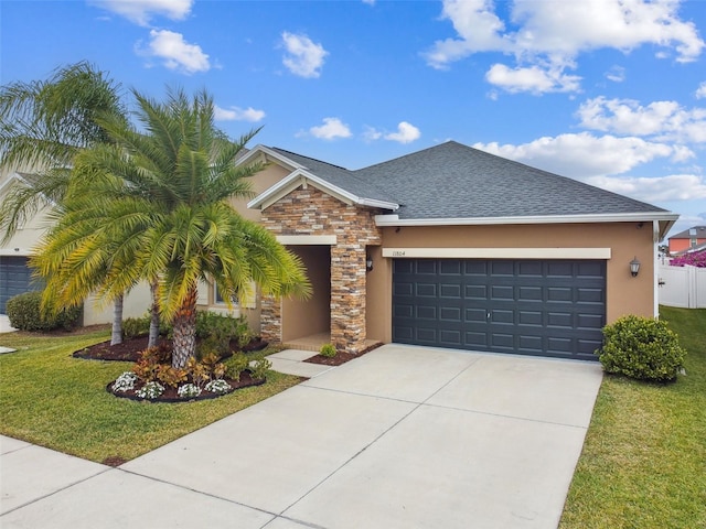 view of front of home with a front lawn and a garage