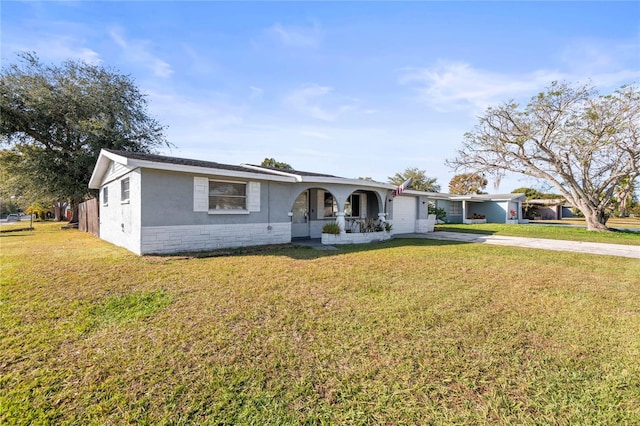 ranch-style house with a porch and a front lawn