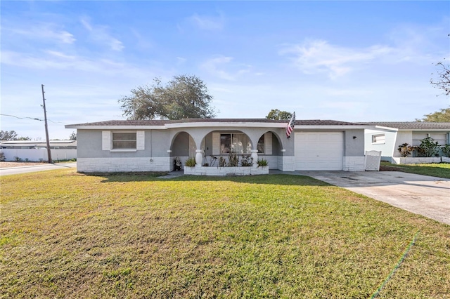 single story home with a porch, a front lawn, and a garage