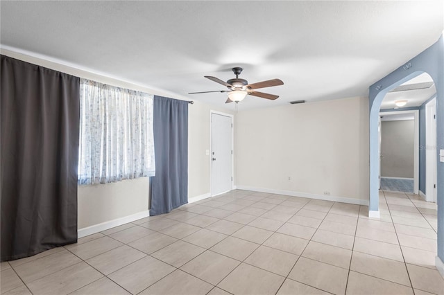 empty room featuring light tile patterned flooring and ceiling fan