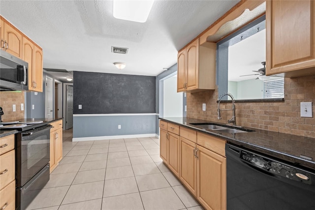 kitchen featuring light brown cabinetry, black appliances, light tile patterned floors, and sink