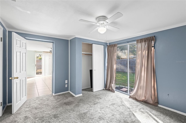 unfurnished bedroom with multiple windows, a closet, ceiling fan, and carpet