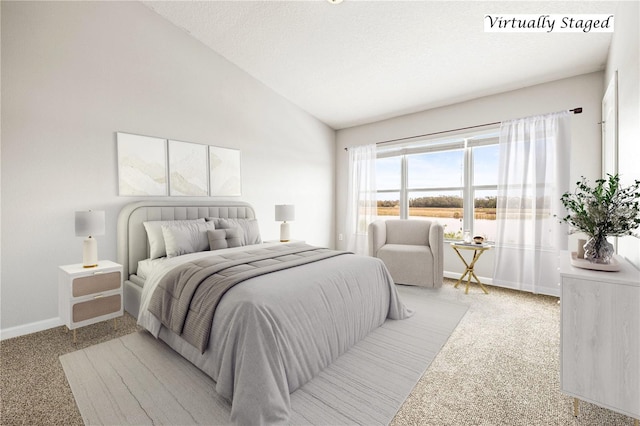 bedroom featuring lofted ceiling, light carpet, and a textured ceiling