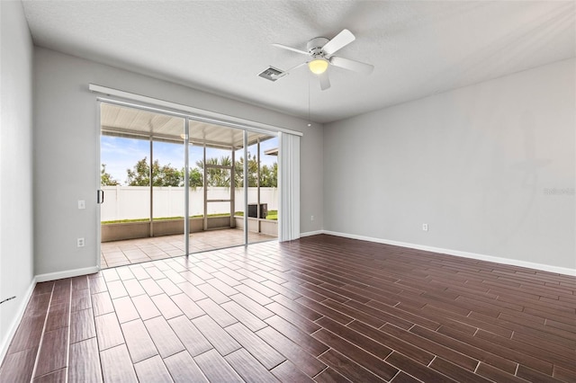 empty room featuring ceiling fan and a textured ceiling