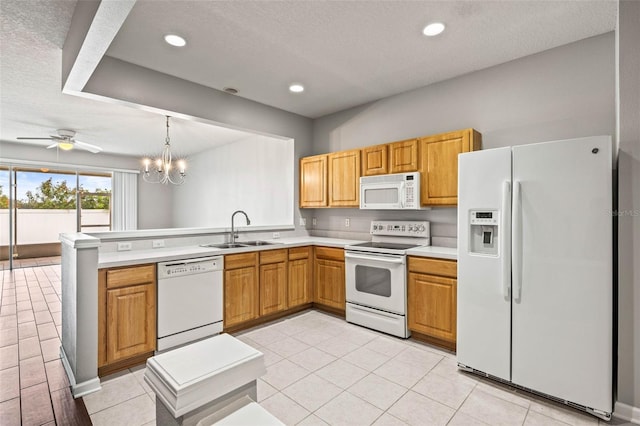 kitchen featuring light tile patterned flooring, ceiling fan with notable chandelier, sink, hanging light fixtures, and white appliances