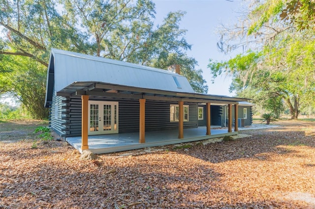 rear view of property with french doors