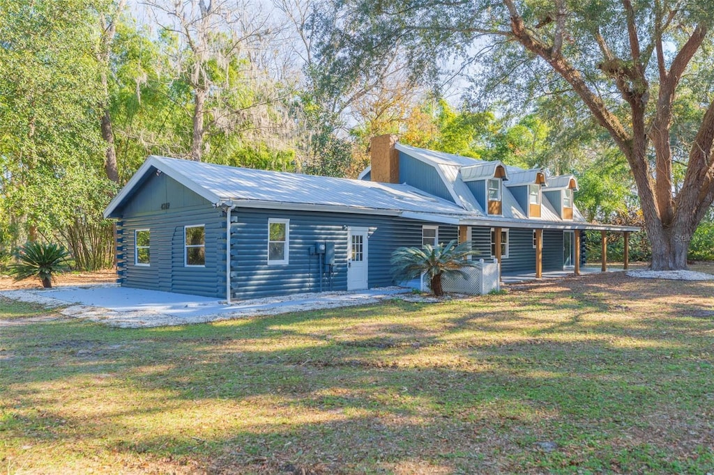 back of property with a patio and a yard