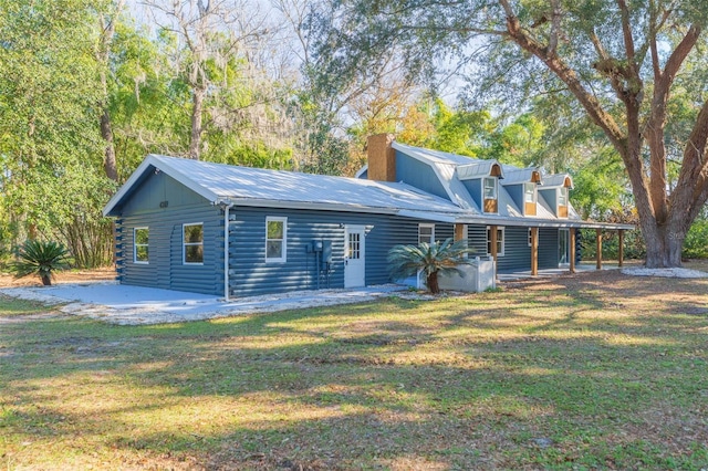 back of property with a patio and a yard