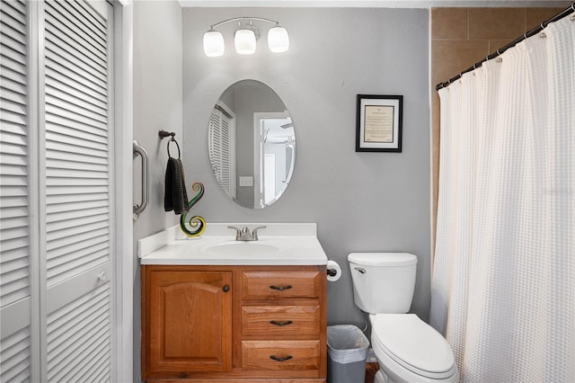 bathroom with toilet, vanity, and a shower with shower curtain