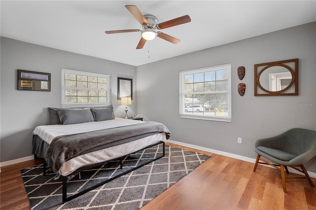 bedroom with ceiling fan and wood-type flooring