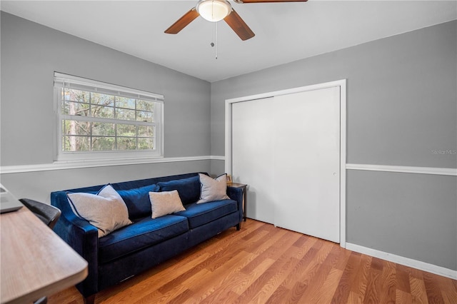 living room with ceiling fan and light hardwood / wood-style floors