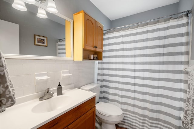 bathroom featuring backsplash, toilet, and vanity