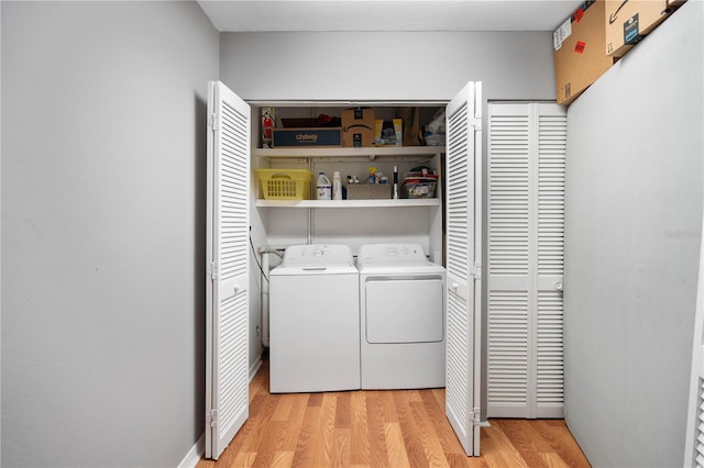 washroom featuring light wood-type flooring and washing machine and dryer