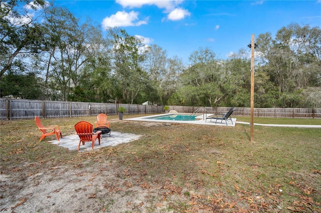 view of yard with a patio area, an outdoor fire pit, and a fenced in pool