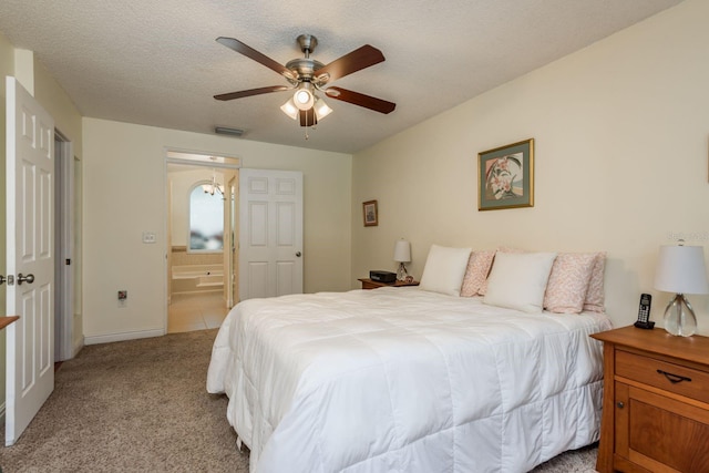 carpeted bedroom with ensuite bathroom, a textured ceiling, and ceiling fan