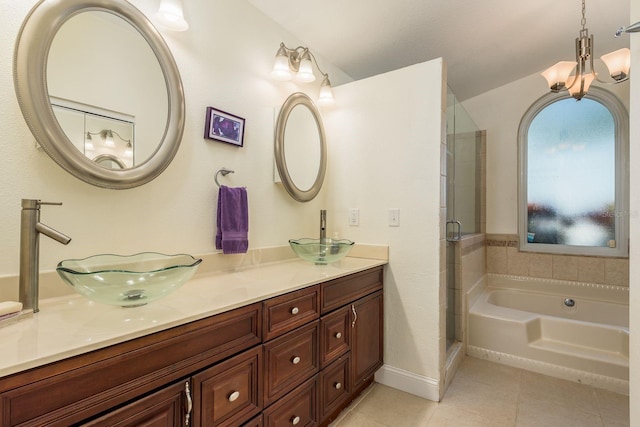 bathroom featuring tile patterned flooring, plus walk in shower, and vanity