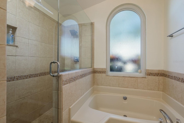 bathroom featuring tile walls and plus walk in shower