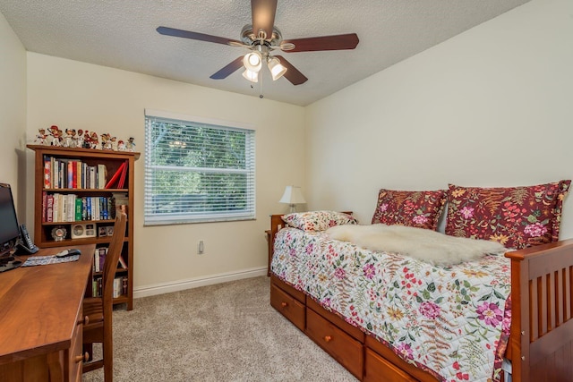 carpeted bedroom with a textured ceiling and ceiling fan