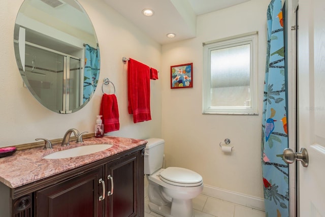 bathroom featuring toilet, tile patterned floors, walk in shower, and vanity